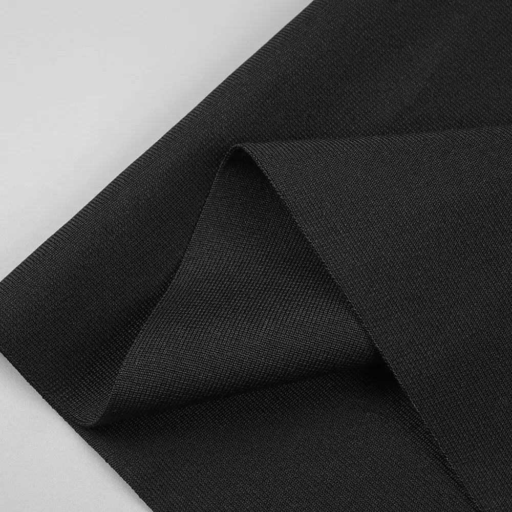 black ribbed knit fabric with a subtle textured weave featured on the back side of a black backless bandage white floral gown highlighting the backless bandage chest design.