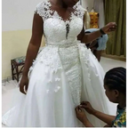 White lace african mermaid detachable wedding dress featuring beaded detailing and a flowing tulle skirt