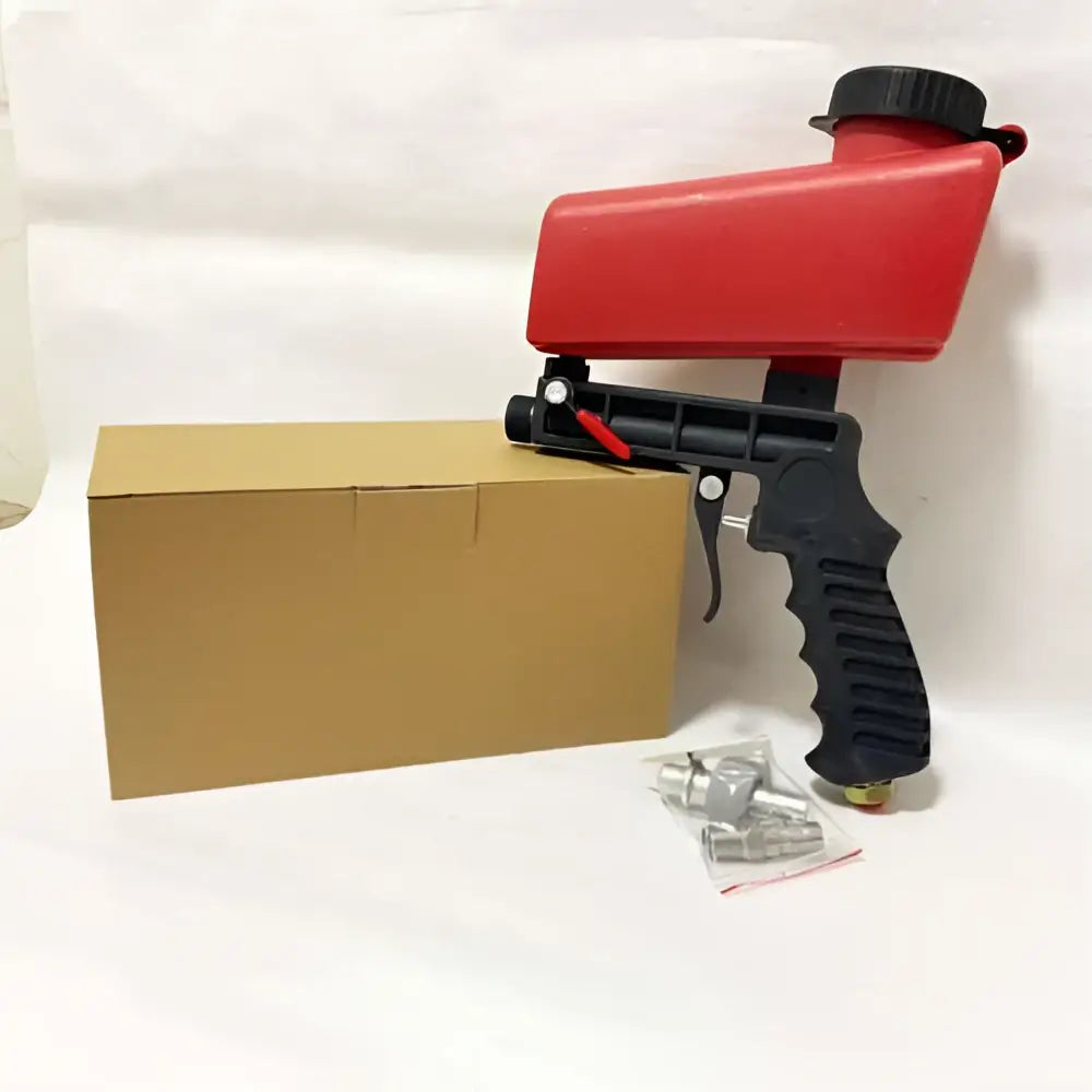 Red and black air portable sandblasting gun with textured grip for brake disc paint and precise sandblasting use