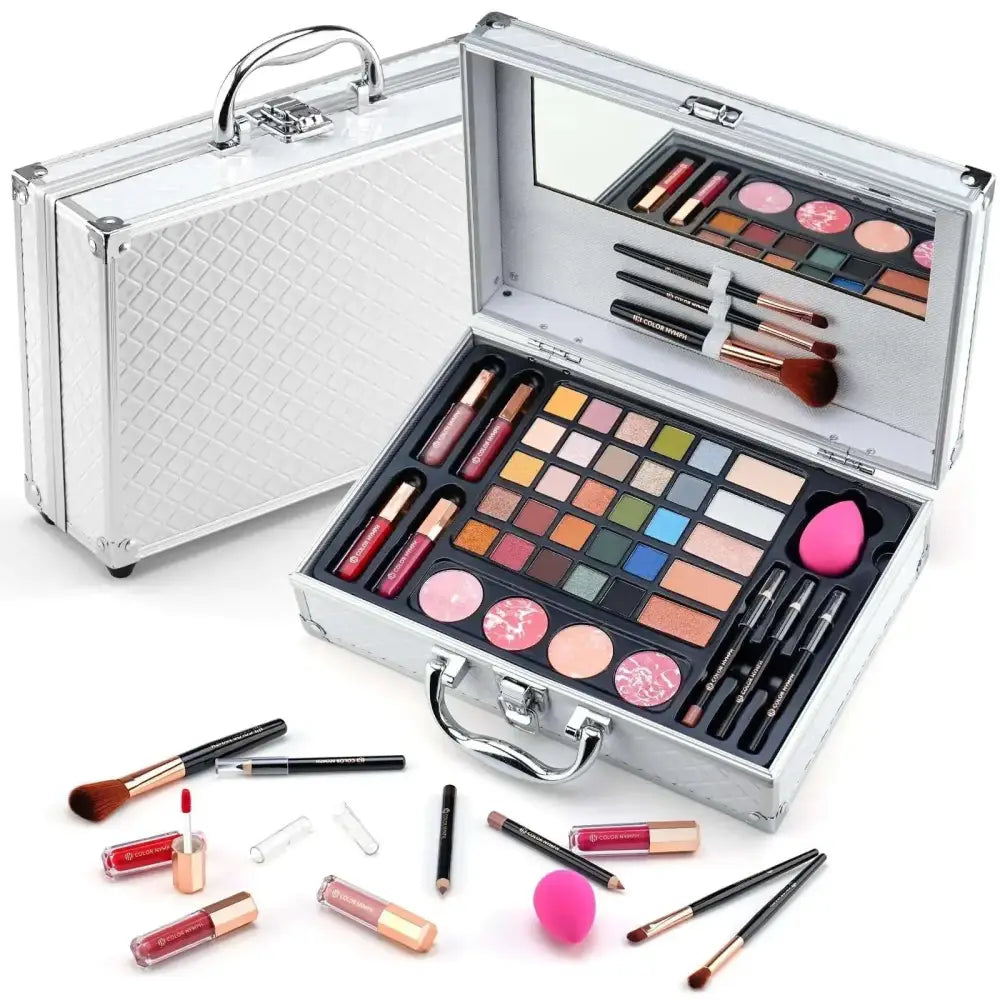 Silver aluminum makeup gift set with mirrored lid and compartments holding eyeshadows lipsticks brushes and sponges