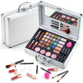 Silver aluminum makeup gift set with mirrored lid and compartments holding eyeshadows lipsticks brushes and sponges