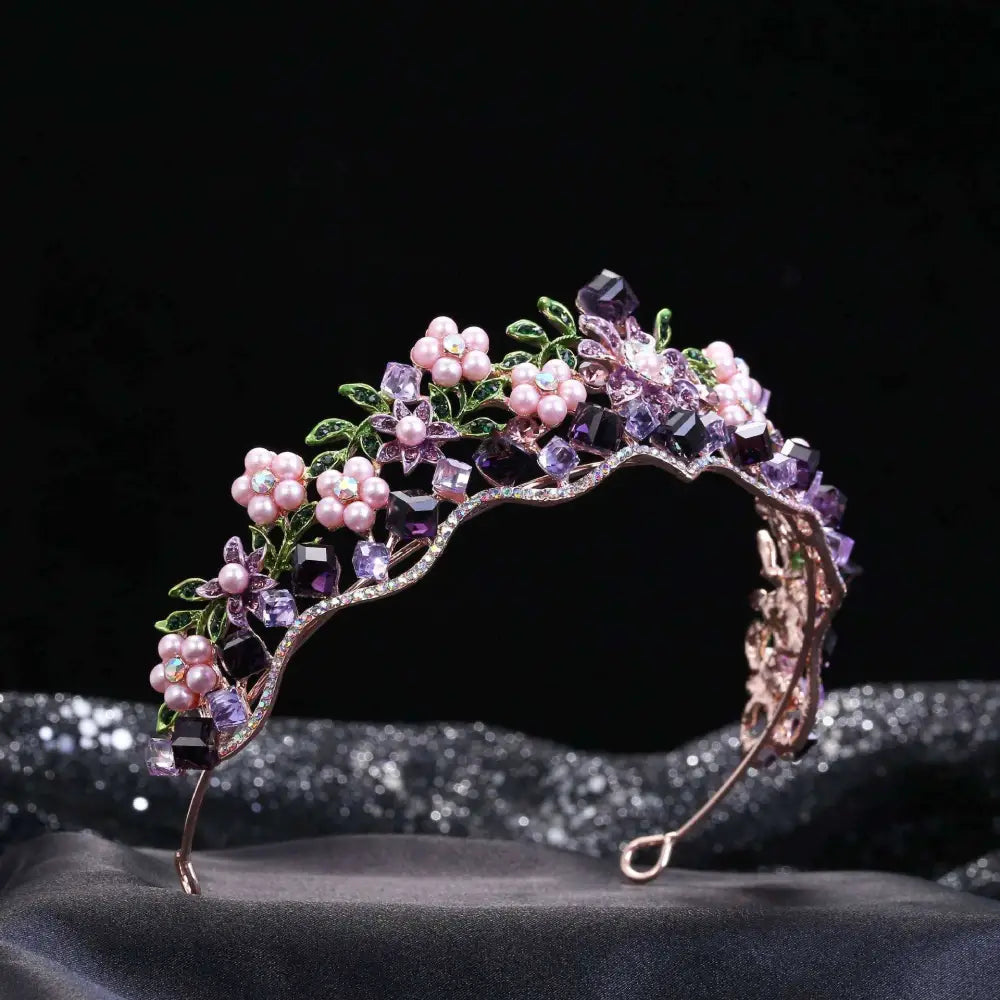 Delicate wedding bridal tiara with alloy crystal flowers, pink pearls, and green leaf accents on gold-toned metal base