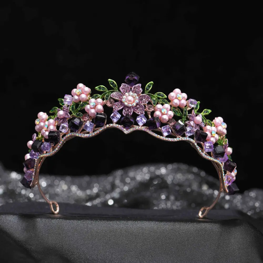 Delicate wedding bridal tiara with alloy crystal flowers, pink pearls, and green leaf accents on gold-toned metal base