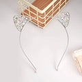 A delicate silver alloy spot drill rabbit ears rhinestone headband with sparkling rhinestones and an iridescent finish
