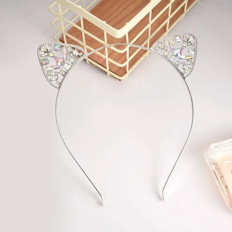 A delicate silver alloy spot drill rabbit ears rhinestone headband with sparkling rhinestones and an iridescent finish