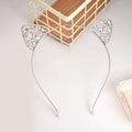 A delicate silver alloy spot drill rabbit ears rhinestone headband adorned with sparkling clear crystals