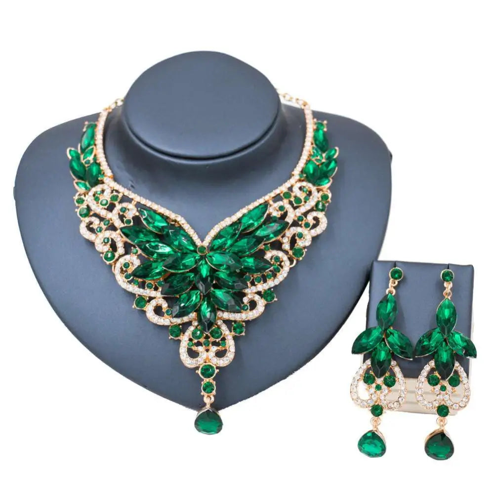 Emerald green leaf-themed necklace and earrings set with gold-tone metalwork for color exaggerated bride jewelry look