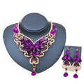Purple and gold color exaggerated bride necklace set with intricate floral design and faceted crystal teardrop pendants