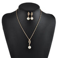 Gold-toned american wedding jewelry pearl necklace and earrings with twisted diamond pendant and leaf-shaped tops