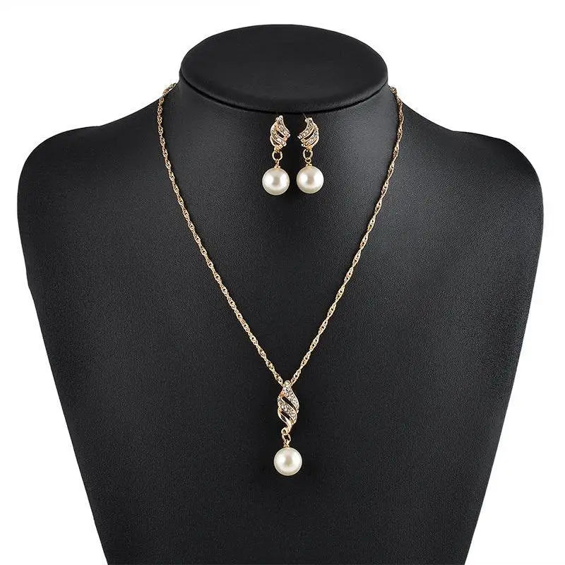 Gold-toned american wedding jewelry pearl necklace and earrings with twisted diamond pendant and leaf-shaped tops