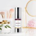 Silver-toned anti-aging regenerating serum bottle with sleek design and purple floral band for wrinkle hydrating care