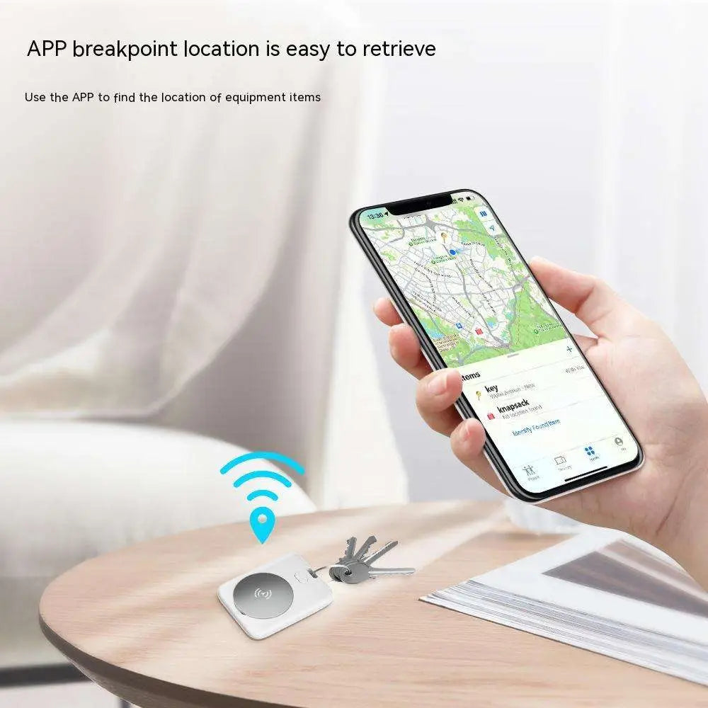 White rectangular apple find my locator pet tracking device with circular metallic logo attached to keys