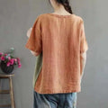A soft rust-colored artistic design half sleeve cotton linen contrast top with relaxed fit and short sleeves