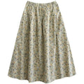 A soft flowing artistic floral washed cotton a-line midi skirt in pale cream with delicate floral pattern in yellow and gray