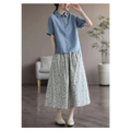 Light blue short-sleeved linen polo shirt with collar and button front paired with artistic floral washed cotton midi skirt