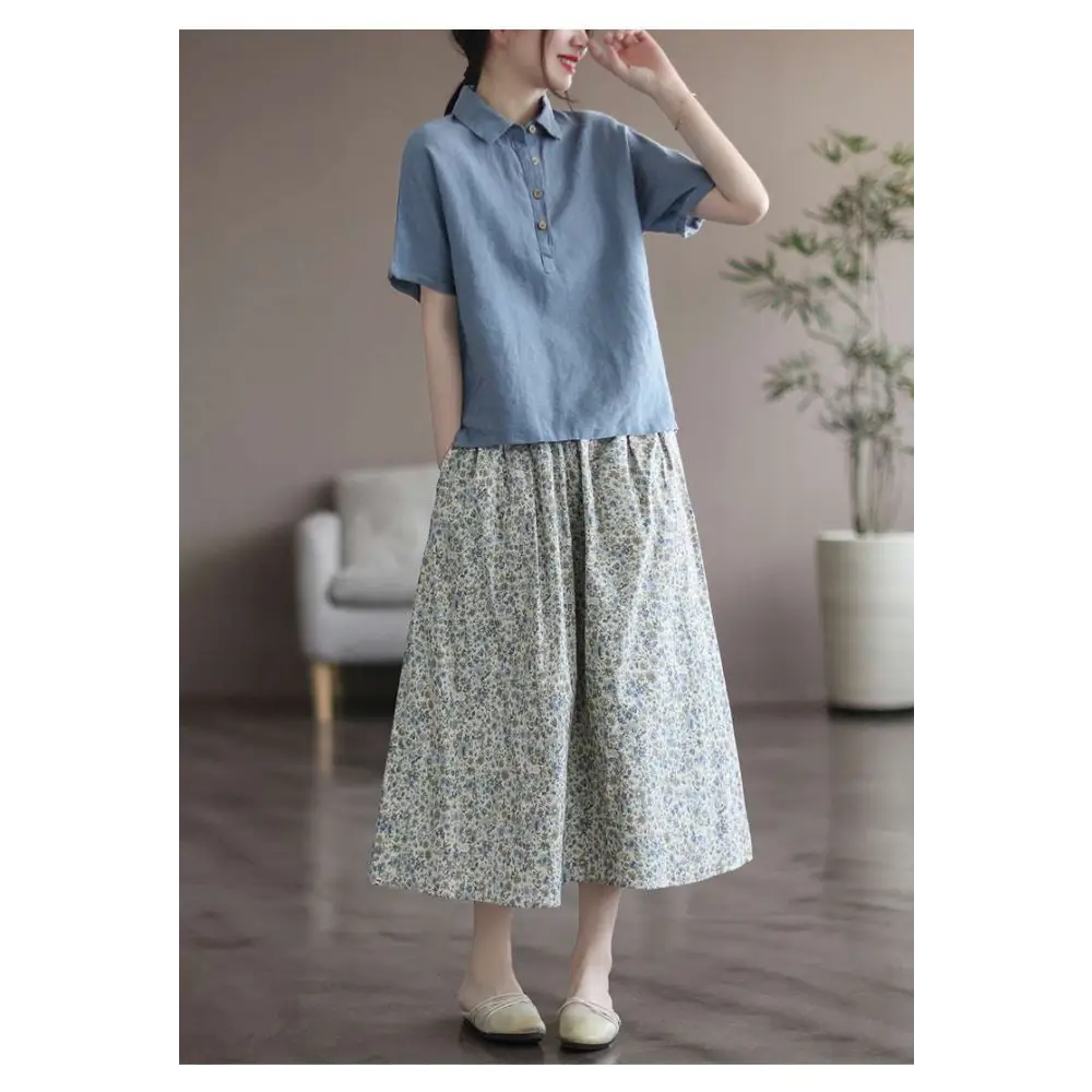 Light blue short-sleeved linen polo shirt with collar and button front paired with artistic floral washed cotton midi skirt