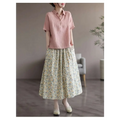 A soft pink short-sleeved linen shirt with classic collar and button front paired with artistic floral washed cotton midi skirt