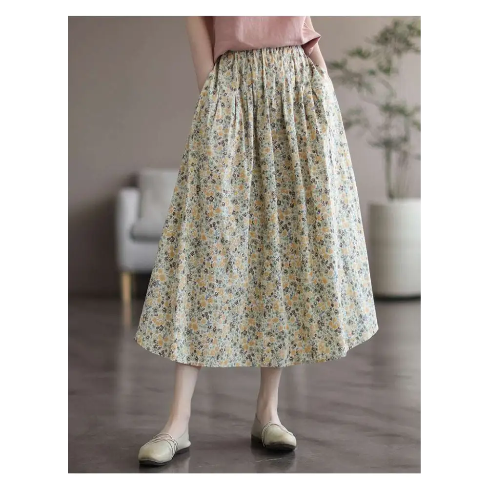 A flowing high-waisted midi skirt in artistic floral washed cotton with a soft cream base and delicate floral pattern