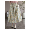 Artistic floral washed cotton midi skirt with delicate floral pattern featuring yellow and green blossoms on pale background