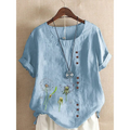 Light blue linen printed casual shirt with embroidered dandelion designs and brown buttons down the front