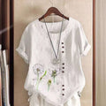 White linen printed casual shirt with embroidered dandelion designs and dark brown buttons down the front