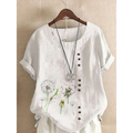 White linen printed casual shirt with delicate embroidered dandelion designs and brown buttons along the front