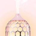Asakusa pink aroma diffuser in rose gold with pink honeycomb-patterned design emitting gentle mist