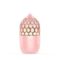 Asakusa pink aroma diffuser with pink honeycomb-patterned glossy finish and gold accent button releasing gentle mist
