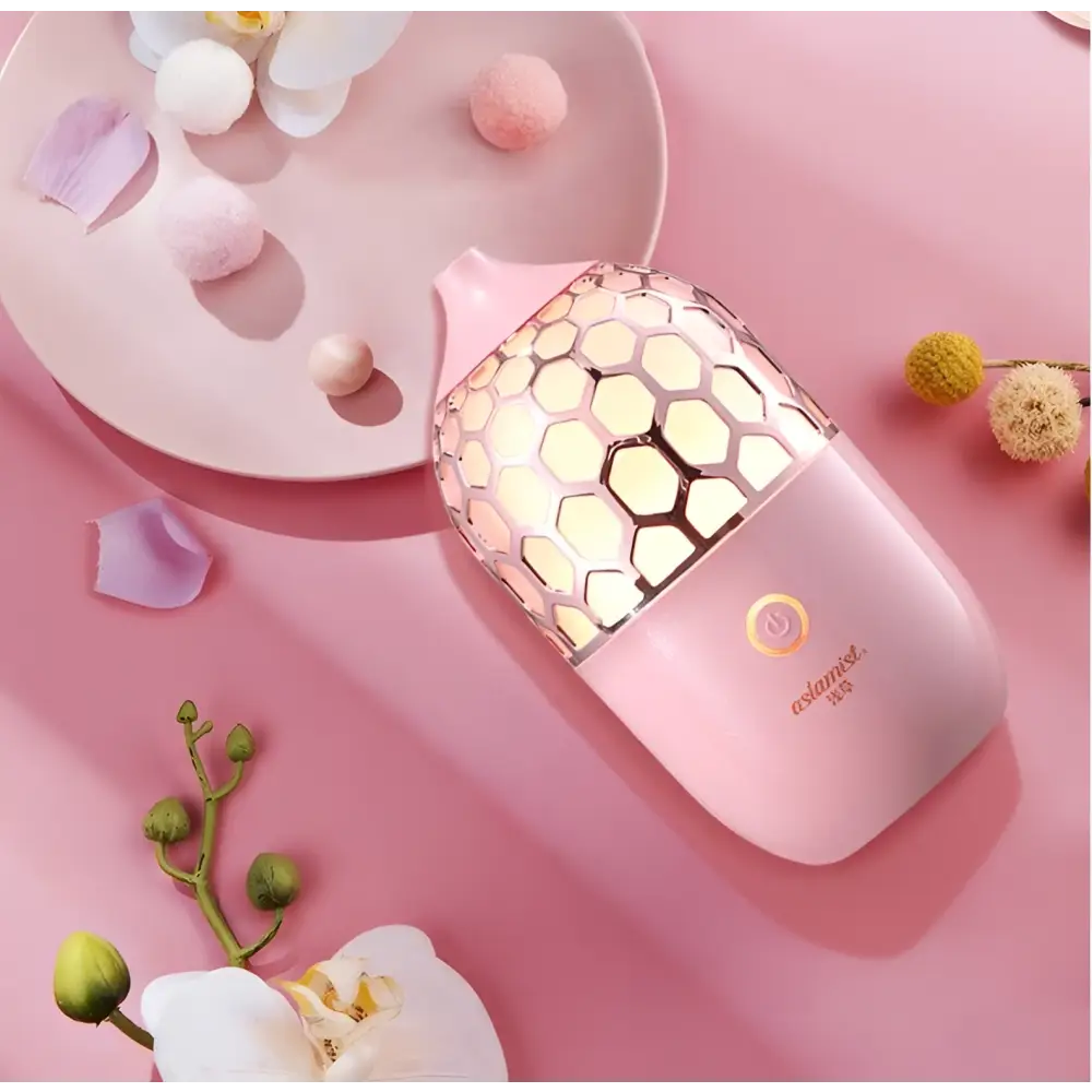 Asakusa pink aroma ultrasonic humidifier with a pink honeycomb-patterned metallic mesh cover and gentle mist output