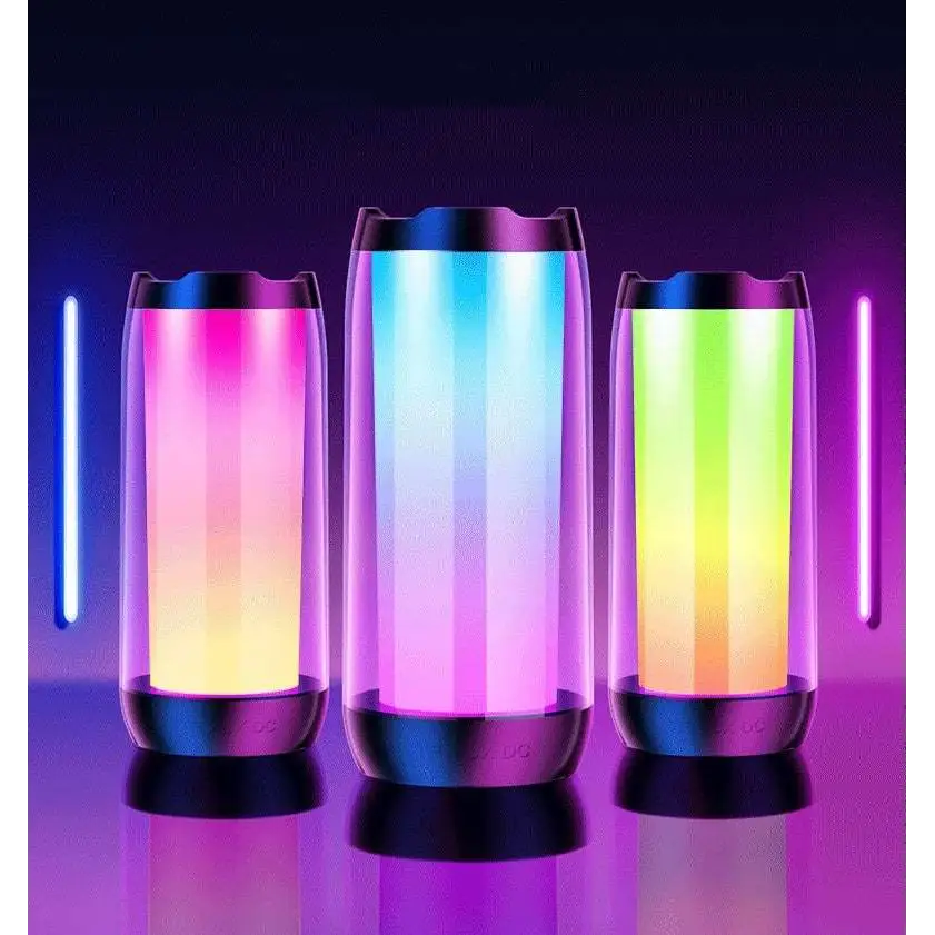 Three cylindrical led ambient light gaming bluetooth speakers with translucent bodies glowing in vibrant gradient hues