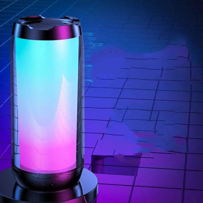 A sleek cylindrical led ambient light gaming bluetooth speaker with black frame and teal to pink gradient lighting