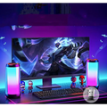 A sleek modern gaming monitor with vibrant graphics and ambient light gaming bluetooth speakers with cylindrical led