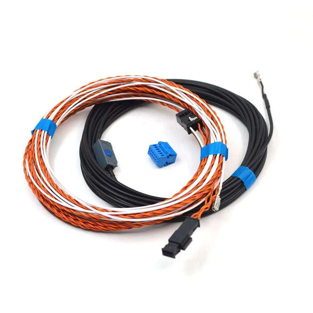 Black plastic avant reverse camera handle with integrated lens and orange-and-white striped wiring connectors, rear view
