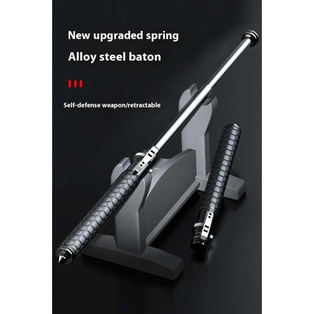 Silver alloy steel telescopic self-defense baton with textured black grip and hexagonal pattern for automatic spring use