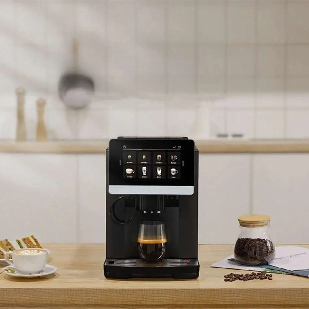 Black automatic touch screen small coffee machine with sleek digital interface and glass cup filled with coffee beneath spout