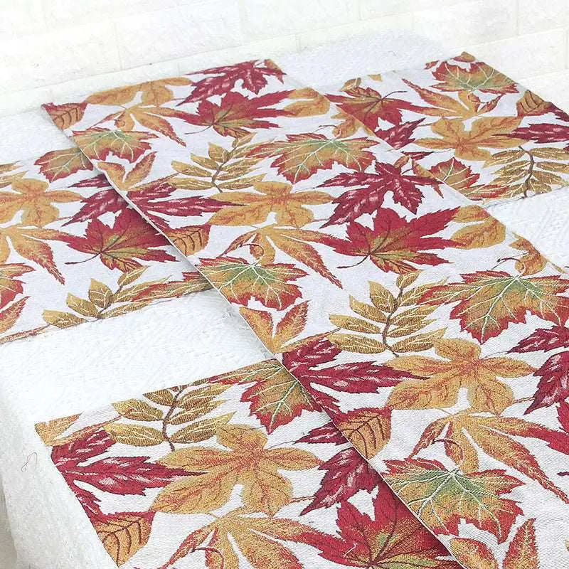 Autumn maple leaf decor table runner with woven texture featuring vibrant red orange and yellow leaves on white background