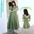 Avocado green sisters satin midi dress in soft olive with square neckline, puffed sleeves, and back lace-up detail