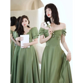 A woman wears an avocado green sisters satin midi dress with puffed sleeves and a gathered bodice