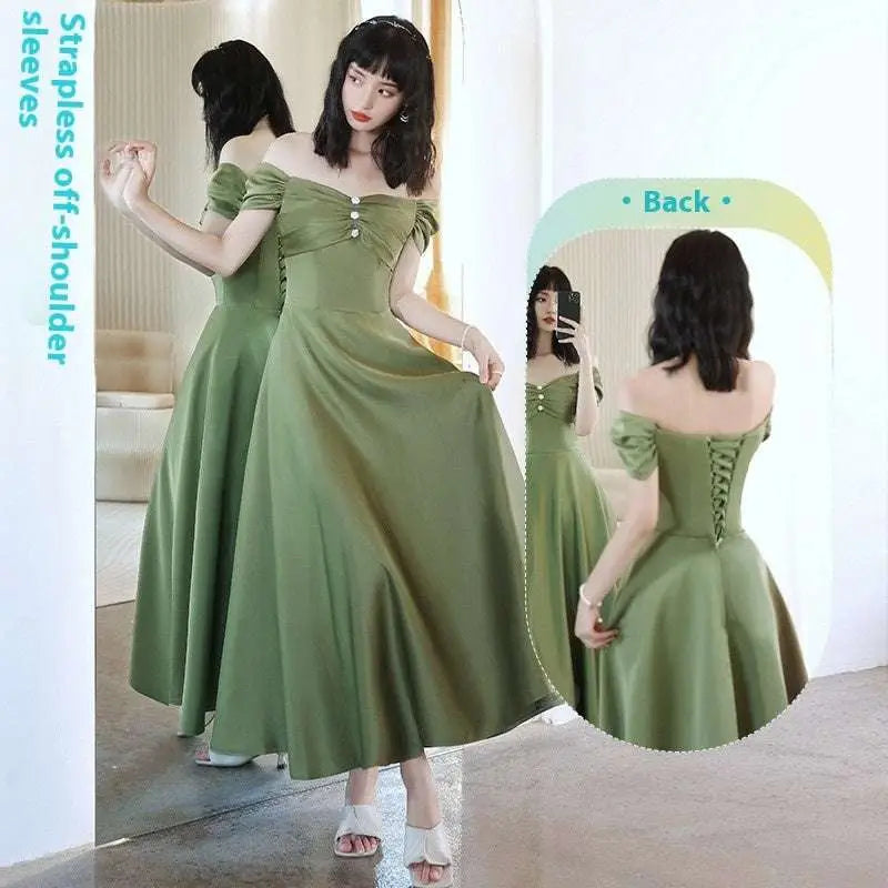 A flowing avocado green sisters satin midi dress with strapless off-shoulder design and back corset lacing