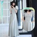 A flowing light gray satin midi dress with puffed sleeves and a v-neckline by avocado green sisters