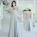 A flowing light gray satin midi dress with off-the-shoulder puffed sleeves and a corseted back from avocado green sisters