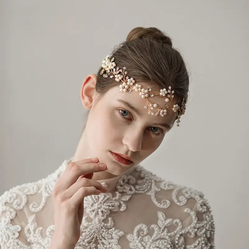 Delicate gold-toned pearl flower wedding headband adorned with clusters of small pearls and intricate floral wirework wedding headband accessories.