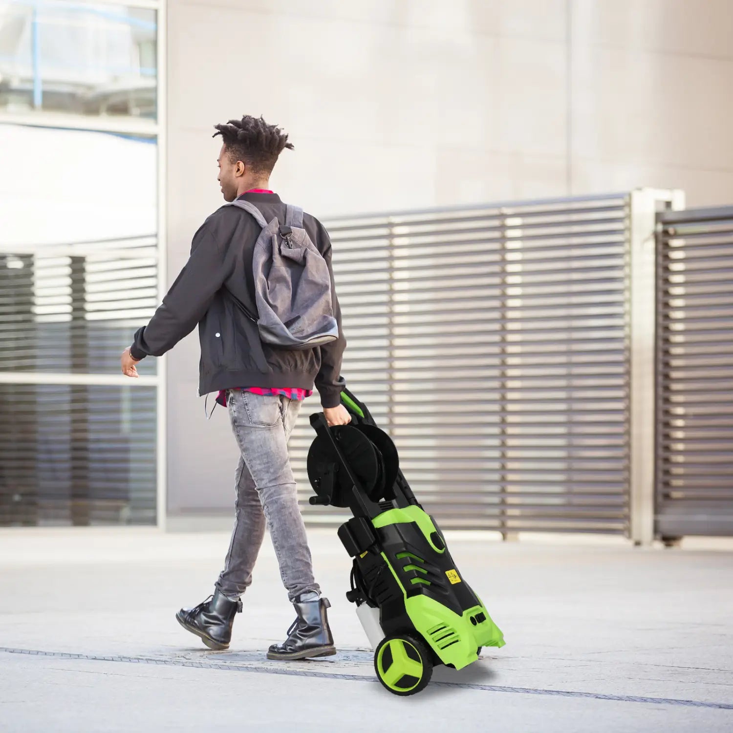 Green and black high pressure cleaner with wheels and a coiled hose designed for efficient cleaning tasks