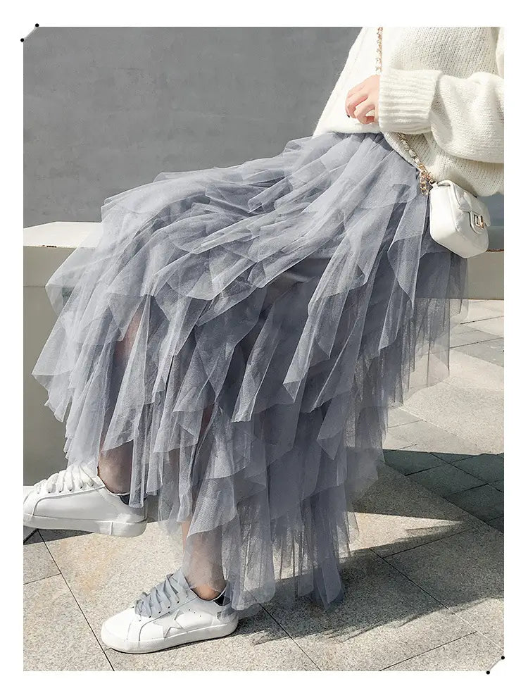 A flowing gray tiered easy matching mesh skirt featuring layered ruffled tiers and soft airy gray tulle with matching mesh stitching.