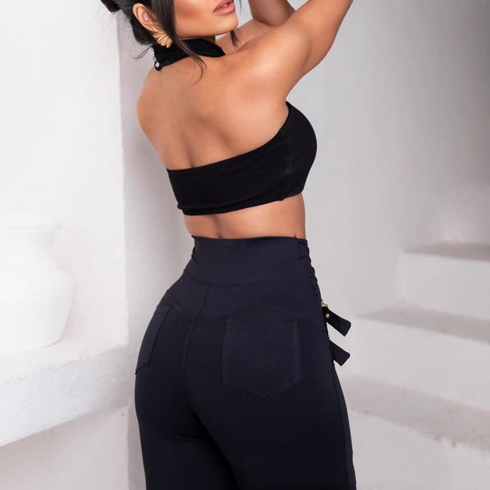 back view of black high waist metallic belt skinny pants featuring side pockets and a decorative bow on the back waistband