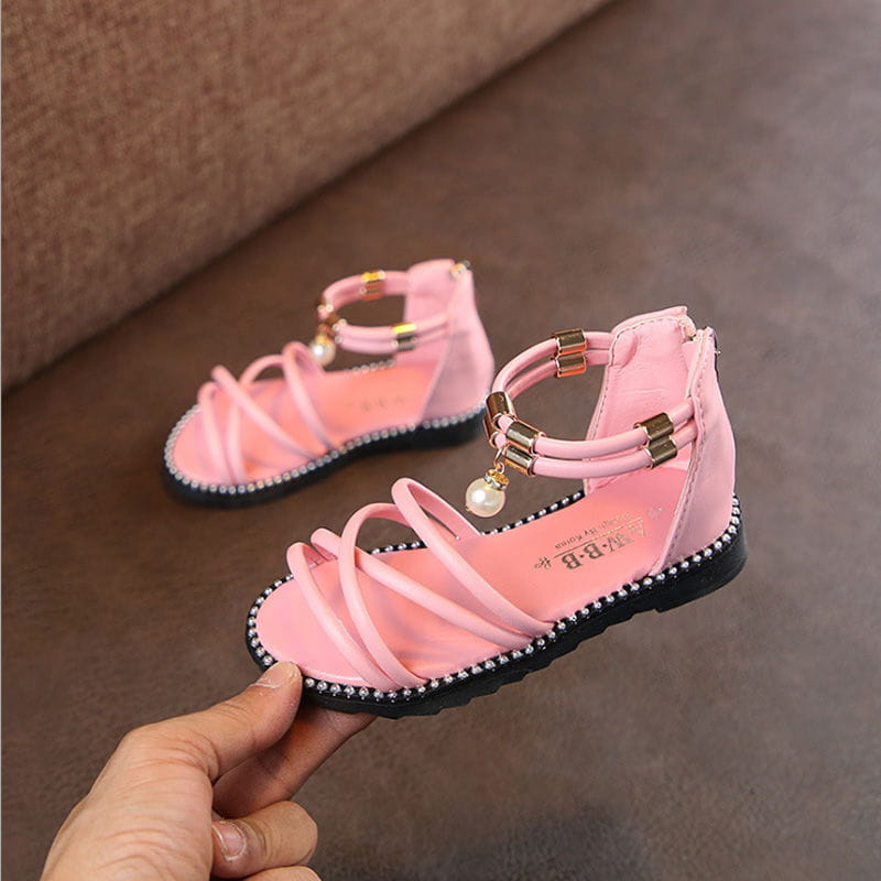 Western style pink girls sandals featuring crisscross straps, gold-tone buckles, and a pearl charm on the ankle strap ideal for net red princesses.
