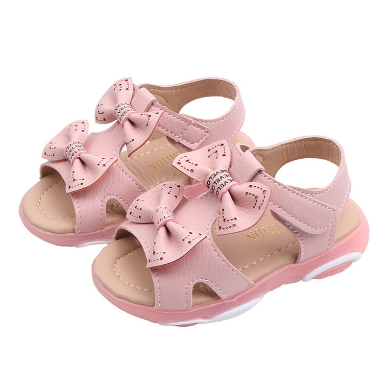 pink children’s sandals with decorative bows and a soft padded sole designed as white led flashing princess shoes with flower flashing princess features
