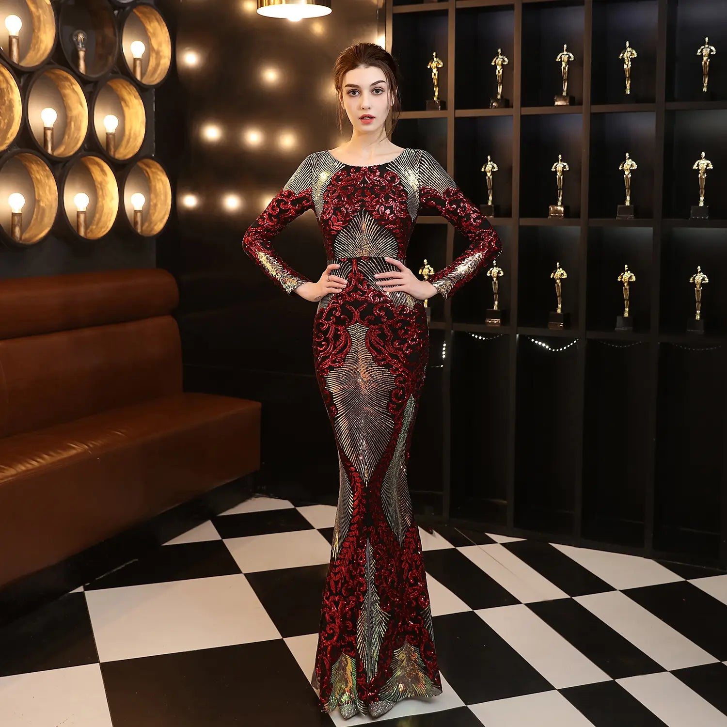 A shimmering burgundy gold mopping long sequin dress with red and silver sequins and fashion stitching mopping design featuring long sleeves in a mermaid style.