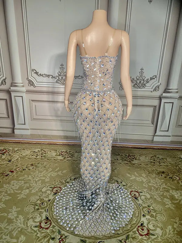 a shimmering silver beaded sexy elegant fishtail gown with a fitted bodice, intricate diamond-like embellishments, and a flowing train