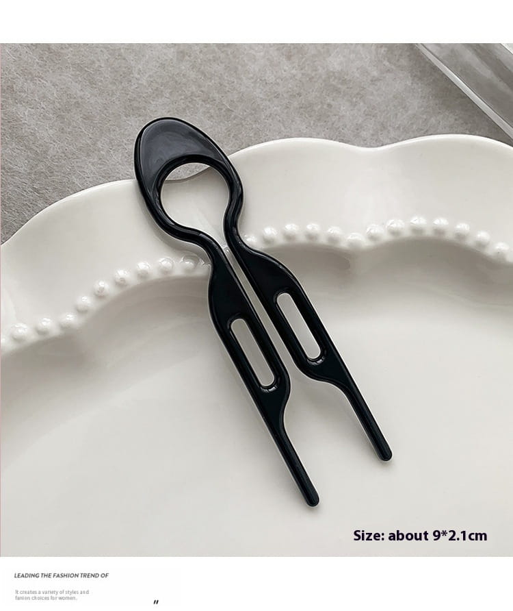 Black glossy plastic tortoiseshell bun lazy updo gadget hair clip with a sleek modern design featuring two prongs and an oval handle for easy head bun lazy styling.